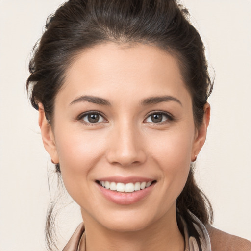 Joyful white young-adult female with long  brown hair and brown eyes