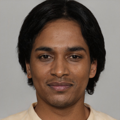 Joyful black young-adult male with short  black hair and brown eyes
