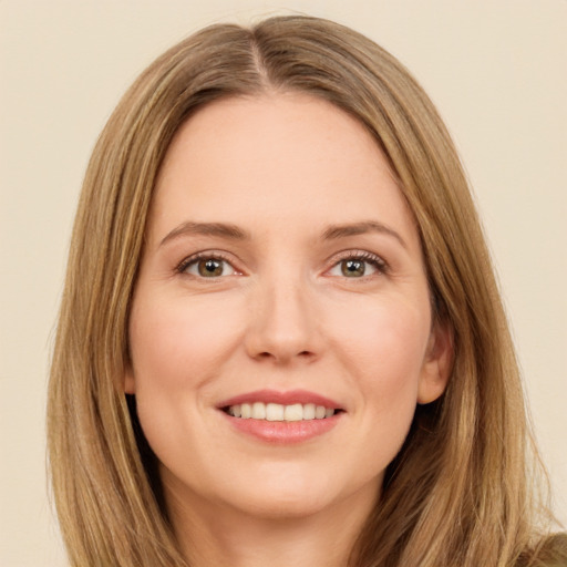 Joyful white young-adult female with long  brown hair and green eyes