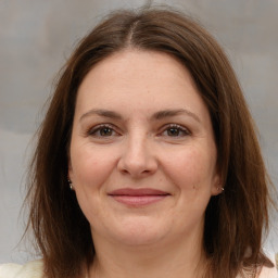 Joyful white adult female with medium  brown hair and brown eyes