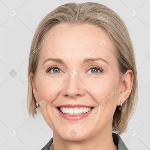 Joyful white adult female with medium  brown hair and grey eyes