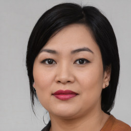 Joyful asian young-adult female with medium  black hair and brown eyes