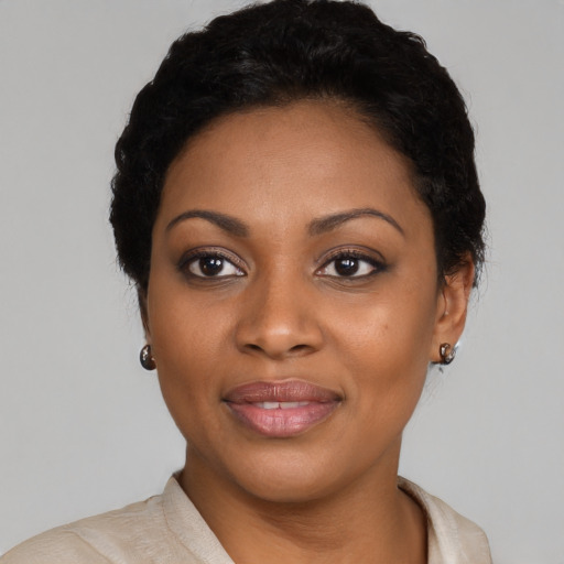 Joyful black young-adult female with short  black hair and brown eyes
