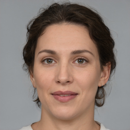 Joyful white adult female with medium  brown hair and brown eyes