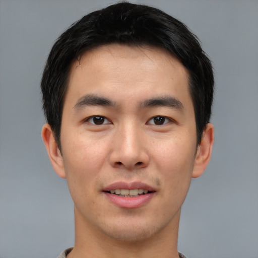 Joyful asian young-adult male with short  brown hair and brown eyes