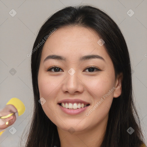 Joyful asian young-adult female with long  brown hair and brown eyes