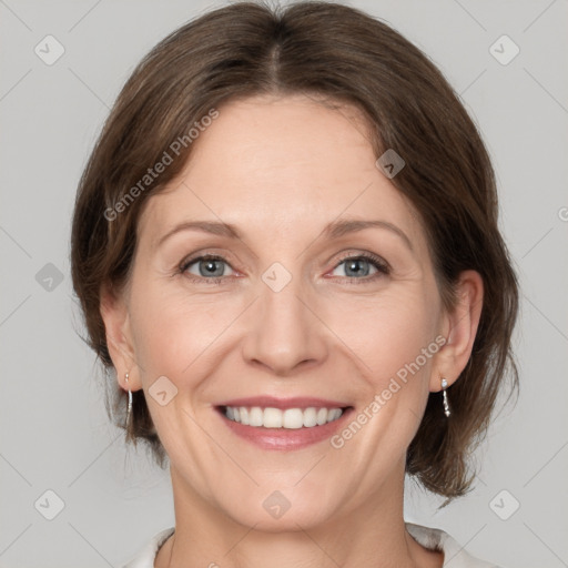 Joyful white adult female with medium  brown hair and grey eyes