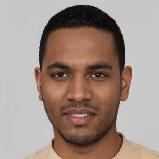 Joyful black young-adult male with short  black hair and brown eyes