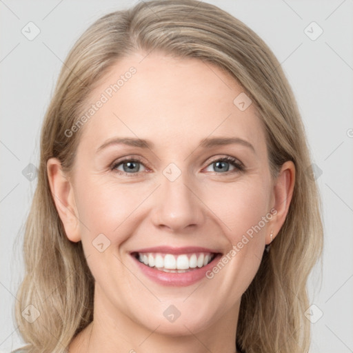 Joyful white young-adult female with long  brown hair and blue eyes