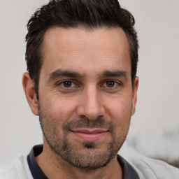 Joyful white adult male with short  brown hair and brown eyes