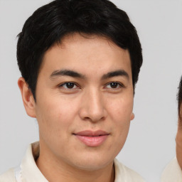 Joyful latino young-adult male with short  brown hair and brown eyes