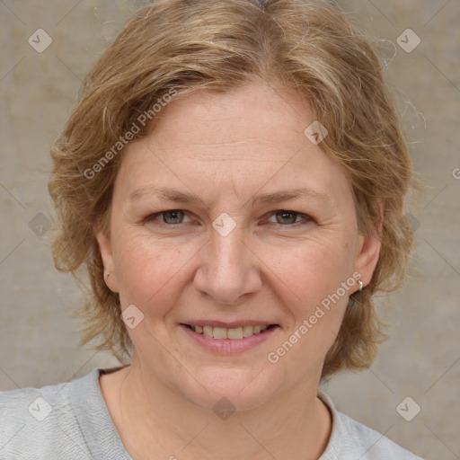 Joyful white adult female with medium  brown hair and blue eyes