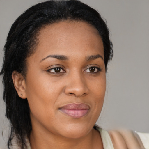 Joyful black young-adult female with medium  brown hair and brown eyes