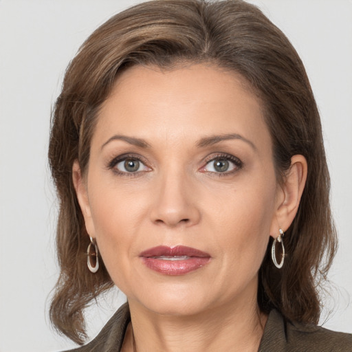 Joyful white adult female with medium  brown hair and brown eyes