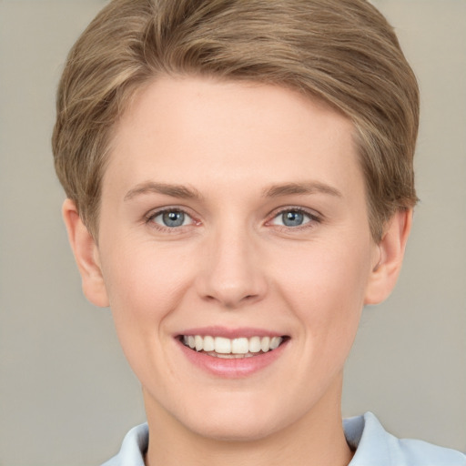 Joyful white young-adult female with short  brown hair and grey eyes