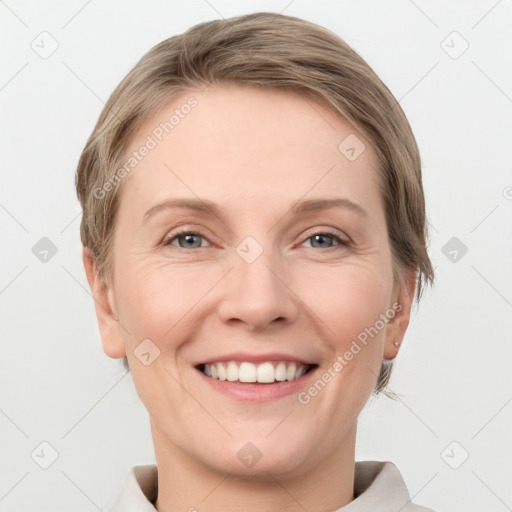 Joyful white young-adult female with short  brown hair and grey eyes