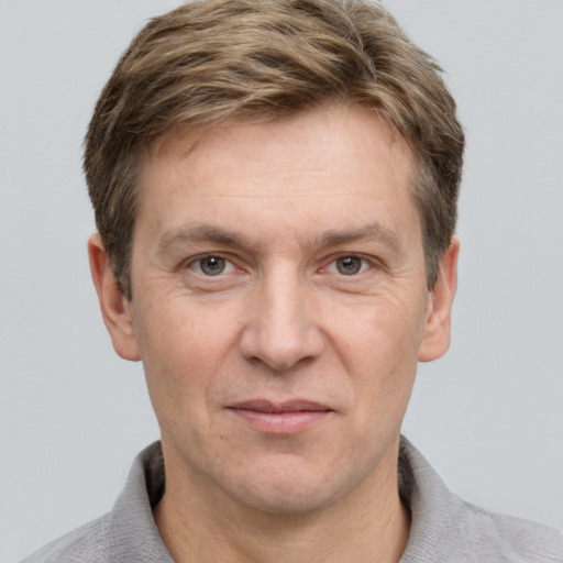 Joyful white adult male with short  brown hair and grey eyes