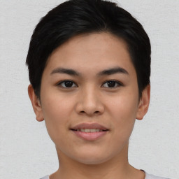 Joyful asian young-adult female with short  black hair and brown eyes