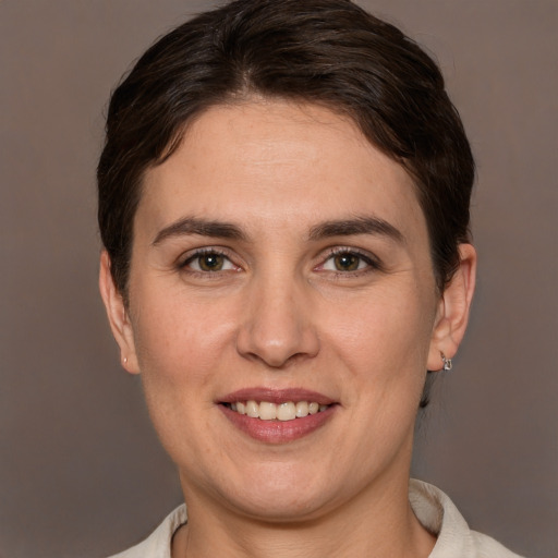 Joyful white adult female with short  brown hair and brown eyes