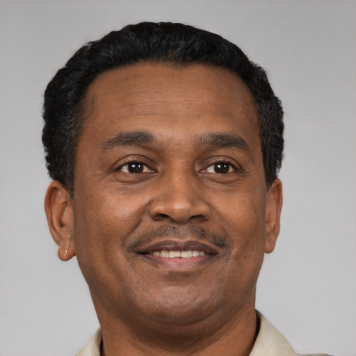 Joyful latino adult male with short  black hair and brown eyes