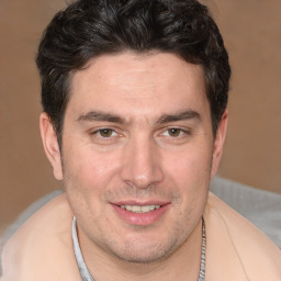 Joyful white adult male with short  brown hair and brown eyes