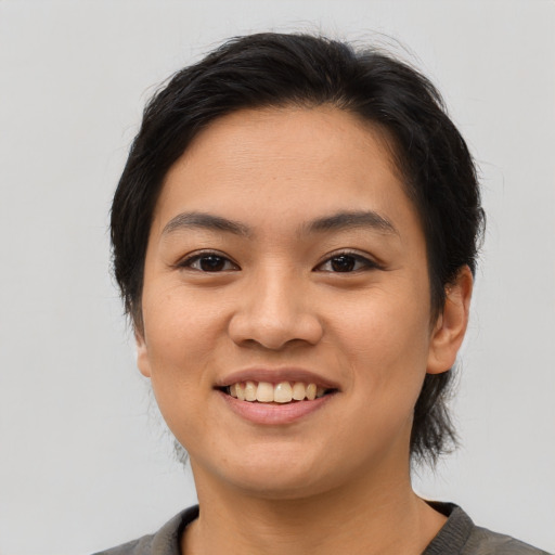 Joyful asian young-adult female with medium  brown hair and brown eyes