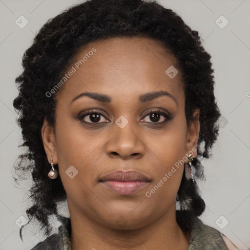 Joyful black young-adult female with long  brown hair and brown eyes