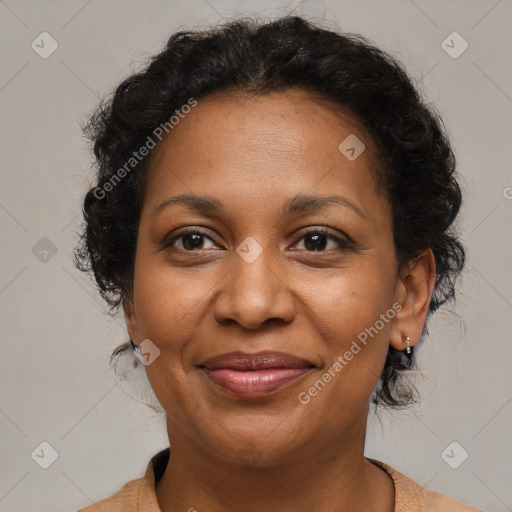 Joyful black adult female with medium  brown hair and brown eyes