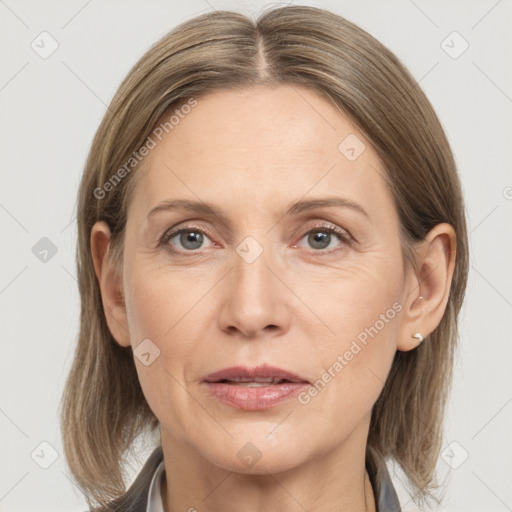 Joyful white adult female with medium  brown hair and grey eyes