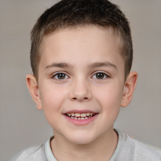 Joyful white child male with short  brown hair and brown eyes