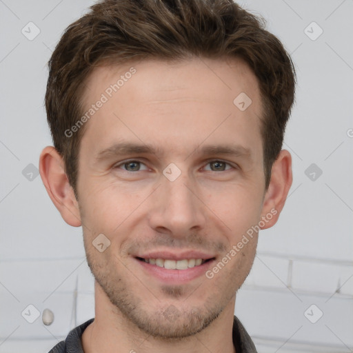 Joyful white young-adult male with short  brown hair and grey eyes