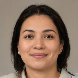 Joyful latino young-adult female with medium  brown hair and brown eyes