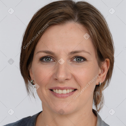 Joyful white adult female with medium  brown hair and grey eyes