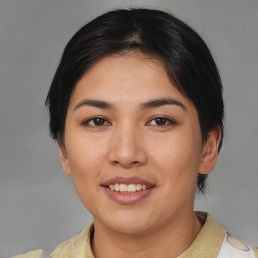 Joyful asian young-adult female with short  brown hair and brown eyes