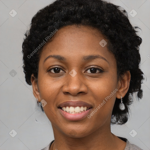 Joyful black young-adult female with short  black hair and brown eyes