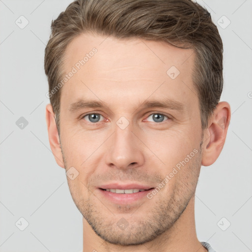 Joyful white young-adult male with short  brown hair and grey eyes