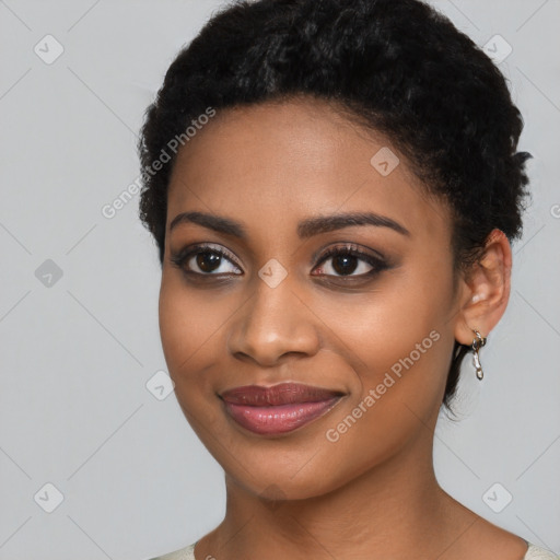 Joyful black young-adult female with short  black hair and brown eyes