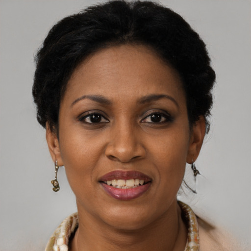 Joyful black adult female with short  brown hair and brown eyes