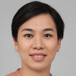 Joyful asian young-adult female with short  black hair and brown eyes