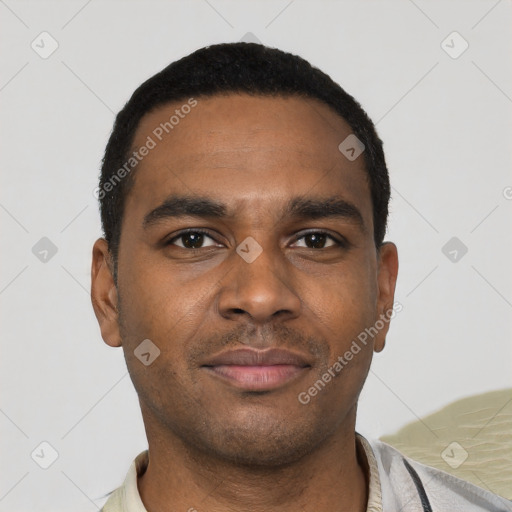 Joyful black young-adult male with short  black hair and brown eyes
