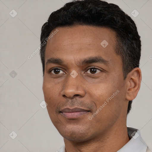 Joyful black young-adult male with short  black hair and brown eyes