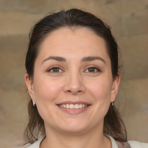 Joyful white young-adult female with medium  brown hair and brown eyes