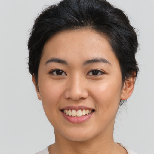 Joyful asian young-adult female with short  brown hair and brown eyes