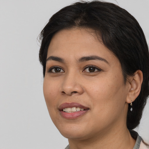 Joyful asian young-adult female with medium  black hair and brown eyes