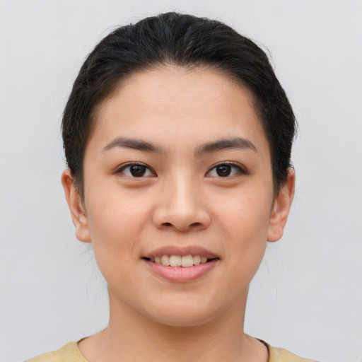 Joyful asian young-adult female with short  brown hair and brown eyes