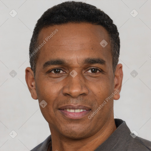 Joyful black adult male with short  black hair and brown eyes