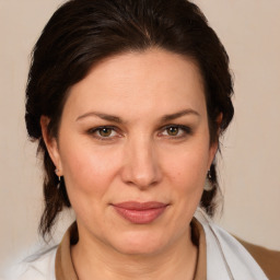 Joyful white adult female with medium  brown hair and brown eyes