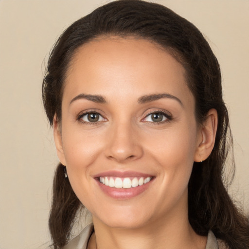 Joyful white young-adult female with long  brown hair and brown eyes