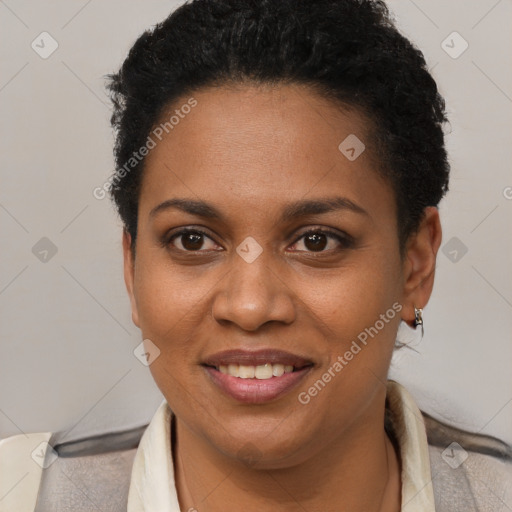 Joyful black young-adult female with short  brown hair and brown eyes