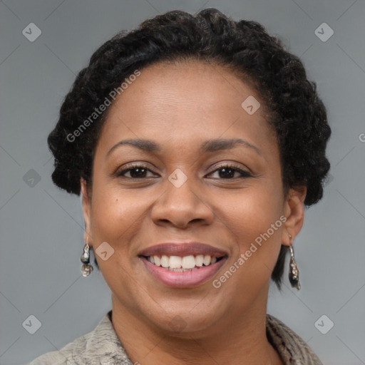 Joyful black adult female with short  brown hair and brown eyes